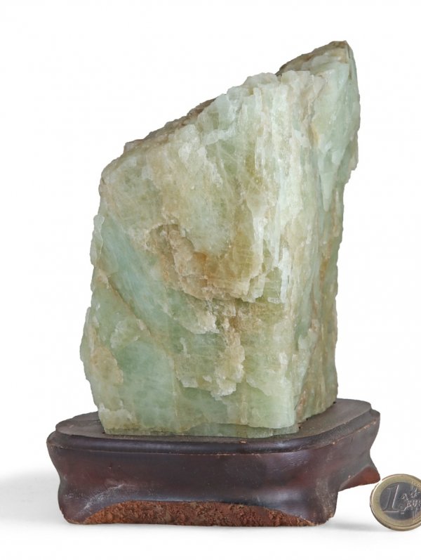Aquamarine raw stone on a wooden base, unique