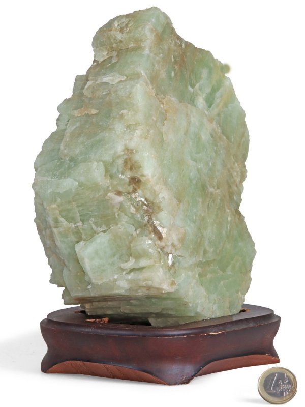 Aquamarine raw stone on a wooden base, unique